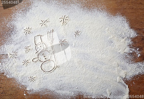 Image of white flour on wooden table