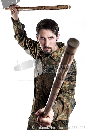 Image of Self defense instructor with bamboo sticks