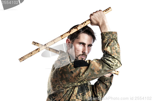 Image of Self defense instructor with bamboo sticks