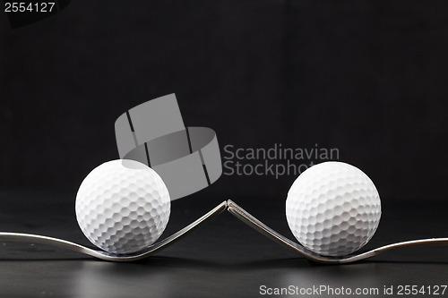 Image of Golf balls on the black background