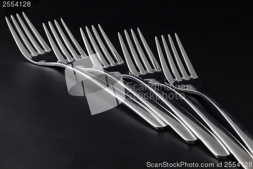 Image of Forks on a black table