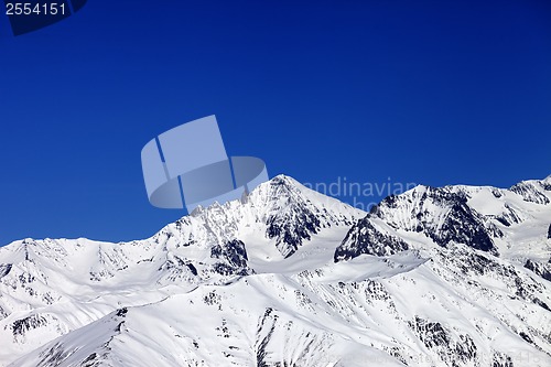 Image of Winter snowy mountains and blue clear sky