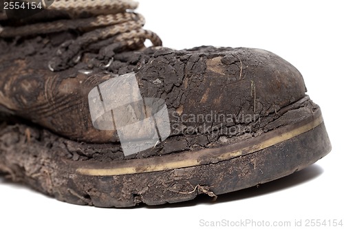 Image of Old dirty hiking boot isolated on white background