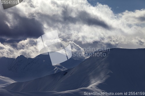 Image of Off piste slope in sunlight clouds at evening