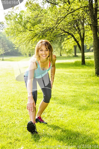 Image of Woman stretching in park