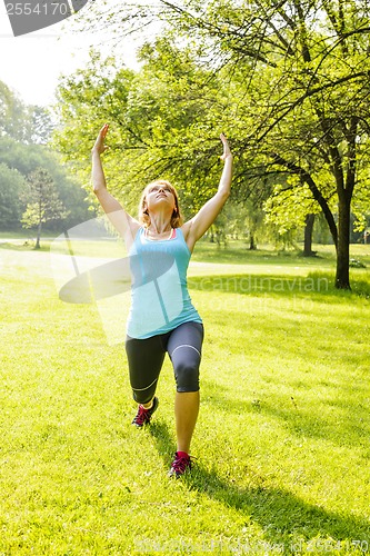 Image of Woman exercising in park