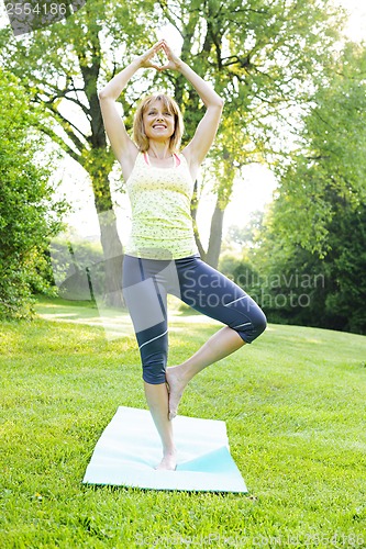 Image of Woman in yoga tree pose