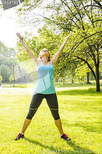 Image of Woman exercising in park