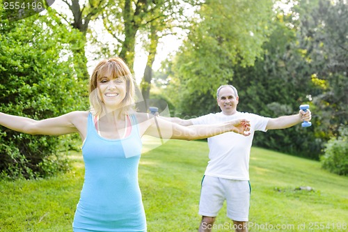 Image of Personal trainer with client exercising outside