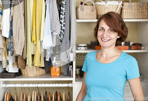 Image of Smiling woman near closet