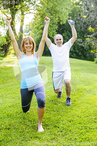 Image of Personal trainer with client exercising outdoors