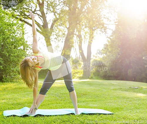 Image of Woman in yoga triangle pose