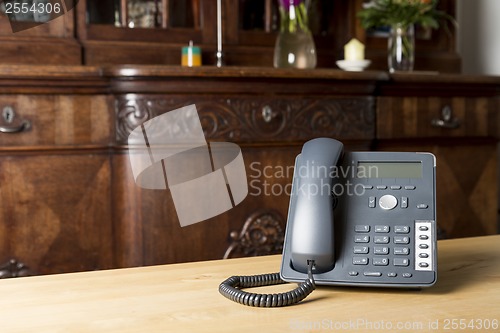 Image of phone on wooden table in living room