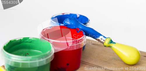 Image of green, red andblue paint with brush