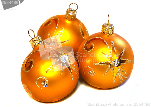 Image of Three orange Christmas balls with golden pattern