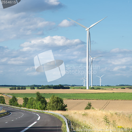 Image of Wind generator turbine on summer landscape