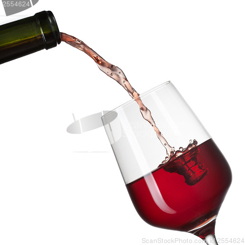 Image of Red wine pouring into glass with splash isolated on white