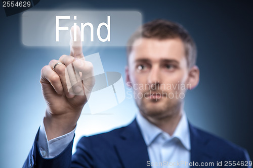 Image of business man pressing Find button on touchscreen