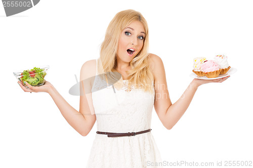 Image of Woman with vegetables and cake