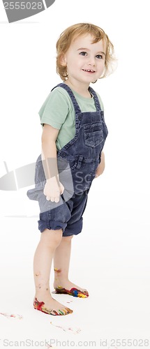 Image of child with painted feet holding trousers