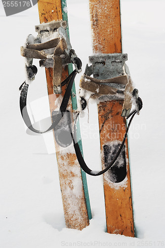 Image of old wooden skis in the snow