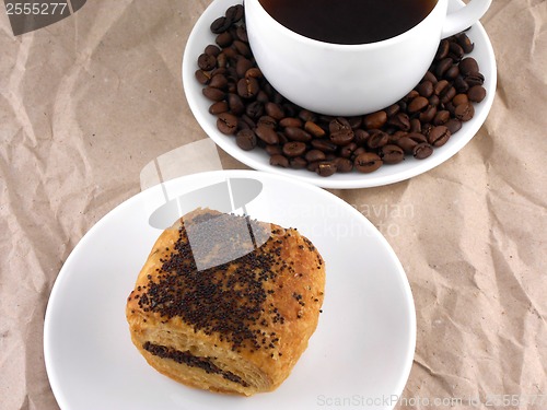 Image of Coffee and coffee beans on white plate with sweet cake