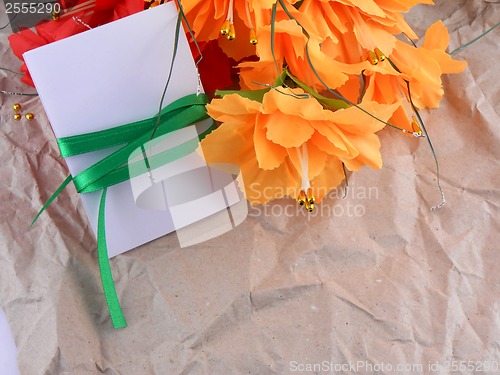 Image of flowers, christmas balls and white invitation card, christmas decorations