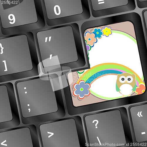 Image of owl on computer keyboard key with flowers