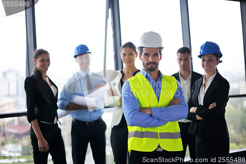 Image of business people and construction engineers on meeting