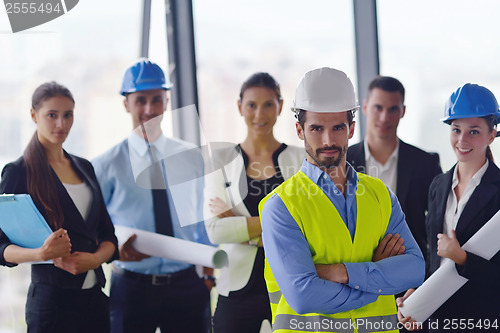 Image of business people and construction engineers on meeting