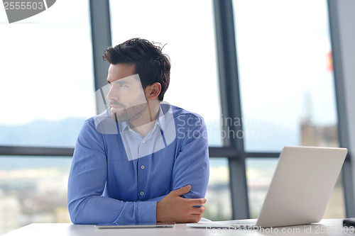 Image of happy young business man at office