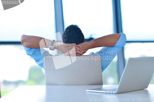 Image of happy young business man at office