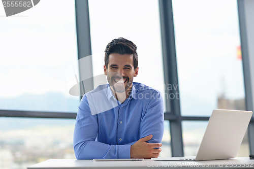 Image of happy young business man at office