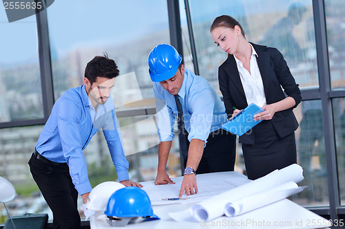 Image of business people and construction engineers on meeting