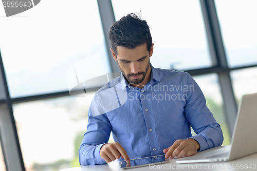 Image of happy young business man at office