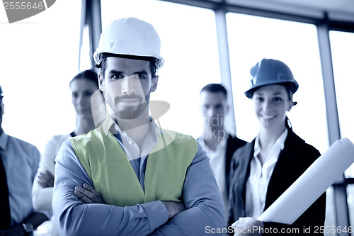 Image of business people and construction engineers on meeting