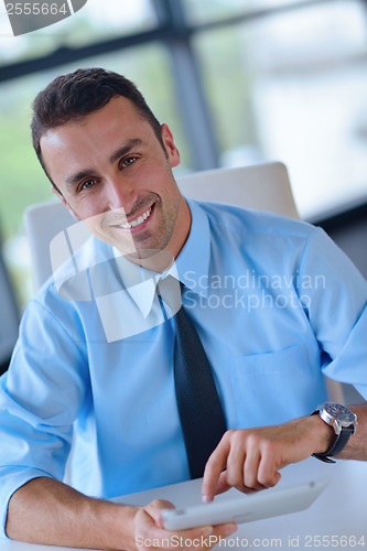 Image of business man using tablet compuer at office