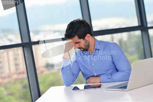 Image of happy young business man at office