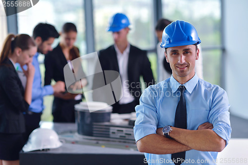 Image of business people and construction engineers on meeting