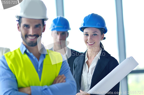 Image of business people and construction engineers on meeting