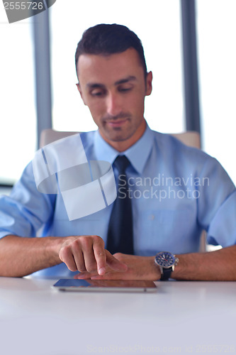 Image of business man using tablet compuer at office