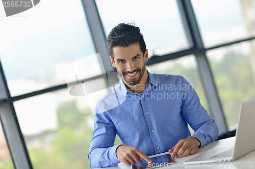 Image of happy young business man at office