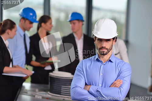 Image of business people and construction engineers on meeting