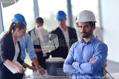 Image of business people and construction engineers on meeting