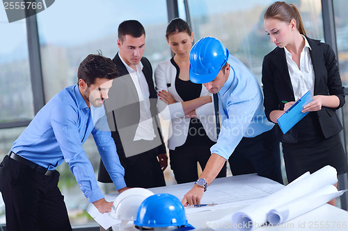 Image of business people and construction engineers on meeting