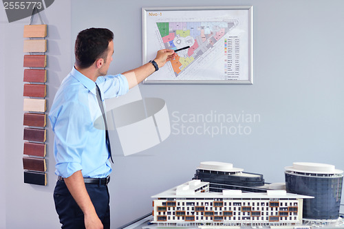 Image of happy young business man at office