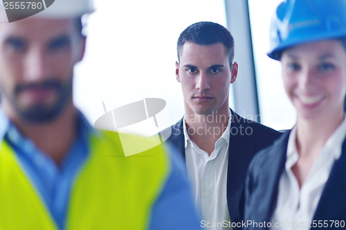 Image of business people and construction engineers on meeting