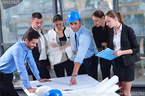 Image of business people and construction engineers on meeting