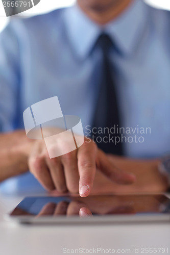 Image of business man using tablet compuer at office