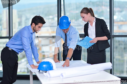 Image of business people and construction engineers on meeting